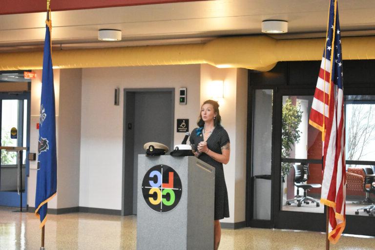 Image shows a veteran student speaking at a podium next to the American and Pennsylvanian flags. The LCCC logo is on the podium.